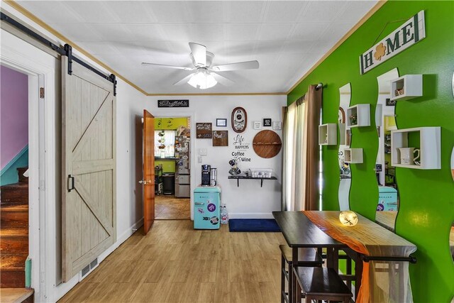 830 Wayne Ave, Ellwood City Law, PA 16117 - dining space featuring a barn door, ceiling fan, ornamental molding, light wood-style floors, and baseboards