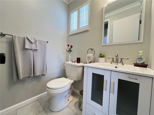bathroom with ornamental molding, baseboards, toilet, marble look tile flooring, and vanity