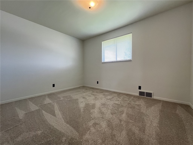 unfurnished room with carpet floors and baseboards