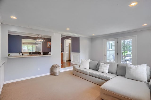 carpeted living area with recessed lighting, a chandelier, and baseboards