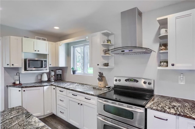 kitchen with extractor fan, stainless steel appliances, open shelves, white cabinetry, and dark stone counters