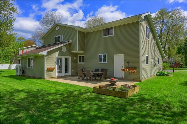rear view of house featuring a lawn, french doors, a patio, and a cooling unit