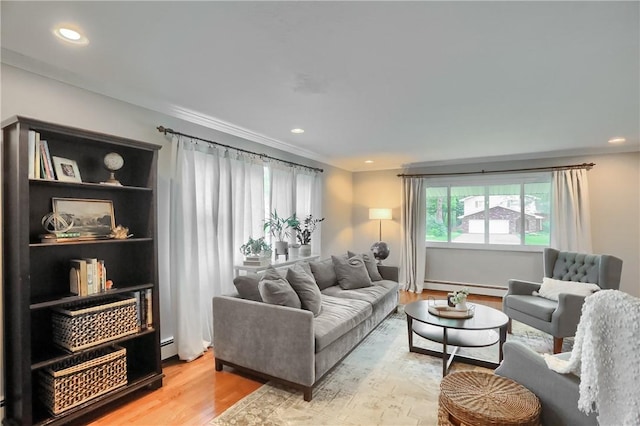 living area featuring a baseboard radiator, wood finished floors, and recessed lighting