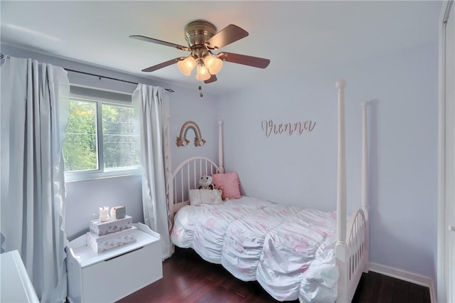 bedroom with dark wood-type flooring and ceiling fan