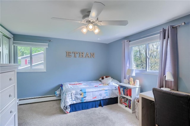 carpeted bedroom with a baseboard radiator and a ceiling fan