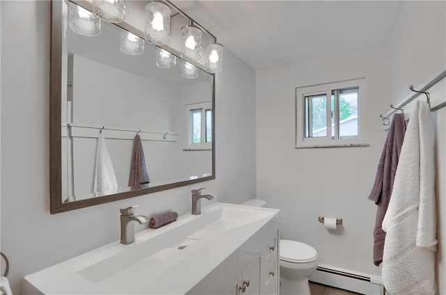 bathroom featuring a baseboard heating unit, plenty of natural light, toilet, and vanity