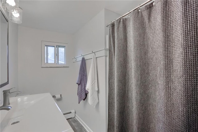 12494 Hickory Dr, Conneaut Lake Cra, PA 16316 - full bath with a baseboard radiator, curtained shower, baseboards, wood finished floors, and vanity