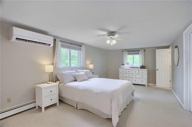 bedroom with a baseboard radiator, a wall mounted AC, light colored carpet, ceiling fan, and baseboards