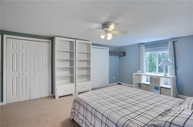 12494 Hickory Dr, Conneaut Lake Cra, PA 16316 - bedroom with two closets, baseboards, light colored carpet, and ceiling fan