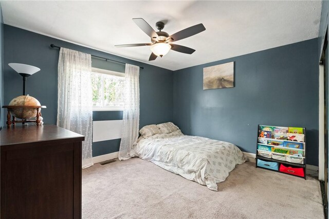 bedroom with carpet, baseboards, and ceiling fan