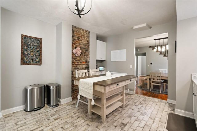dining area with light wood-type flooring and baseboards
