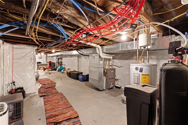 unfinished basement featuring electric water heater and heating unit