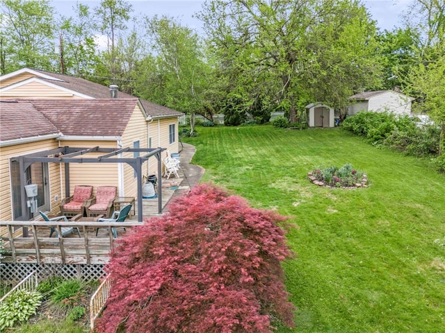 128 Evergreen Dr, Peters Twp, PA 15317 - view of green lawn with a pergola, a storage shed, a wooden deck, and an outbuilding