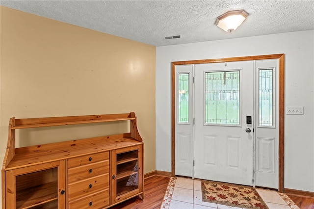 128 Evergreen Dr, Peters Twp, PA 15317 - entrance foyer with a textured ceiling, baseboards, and light wood-style flooring