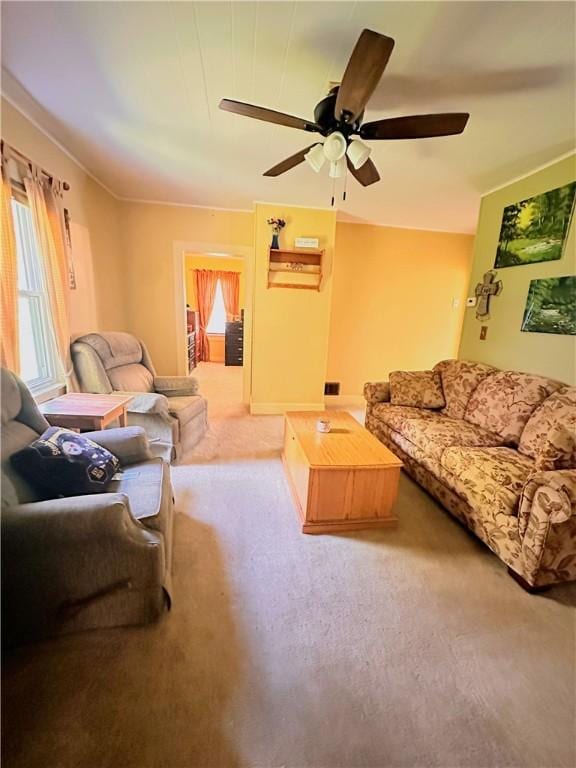carpeted living room with ceiling fan