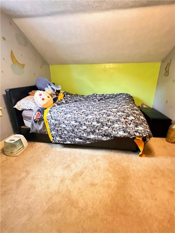 carpeted bedroom featuring vaulted ceiling