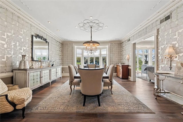 dining space with a chandelier, ornamental molding, healthy amount of natural light, dark wood finished floors, and recessed lighting