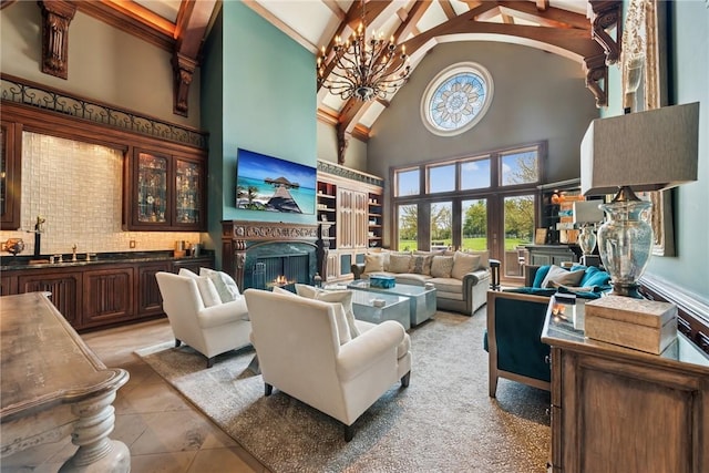 living room with high vaulted ceiling, a lit fireplace, a chandelier, beamed ceiling, and light tile patterned flooring