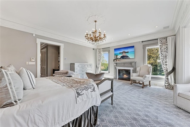 carpeted bedroom with crown molding, multiple windows, a chandelier, a glass covered fireplace, and recessed lighting