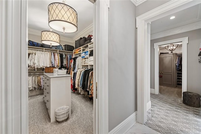 walk in closet with carpet flooring and a chandelier