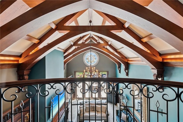 detailed view of a chandelier, beam ceiling, and arched walkways