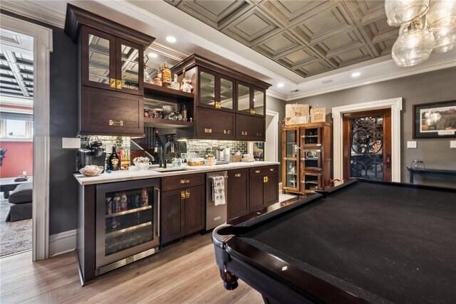 indoor wet bar with wine cooler, light wood-style floors, decorative backsplash, stainless steel dishwasher, and an ornate ceiling