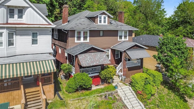 554 Forest Ave, Bellevue, PA 15202 - american foursquare style home featuring stairs, a chimney, and board and batten siding