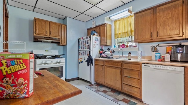 554 Forest Ave, Bellevue, PA 15202 - kitchen featuring white appliances, under cabinet range hood, a sink, light countertops, and light floors