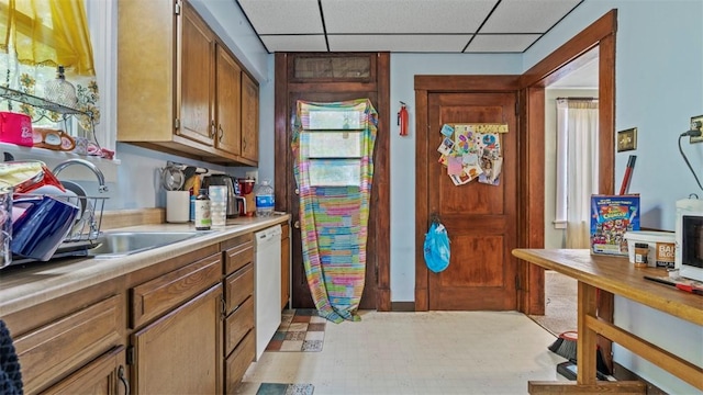 554 Forest Ave, Bellevue, PA 15202 - kitchen featuring dishwasher, a drop ceiling, light countertops, and brown cabinetry