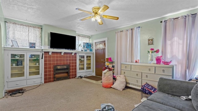 554 Forest Ave, Bellevue, PA 15202 - living area featuring a tile fireplace, carpet floors, a textured ceiling, and a ceiling fan