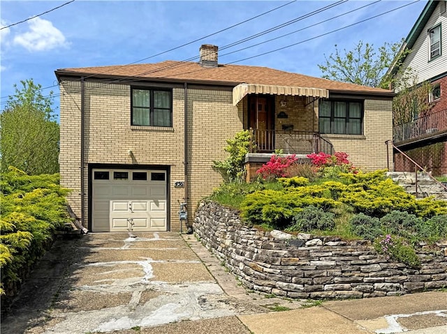 456 Antenor Ave, Overbrook, PA 15210 - view of front of house featuring a garage, brick siding, driveway, and a chimney