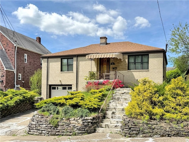 456 Antenor Ave, Overbrook, PA 15210 - view of front of home featuring a garage, brick siding, a chimney, and driveway