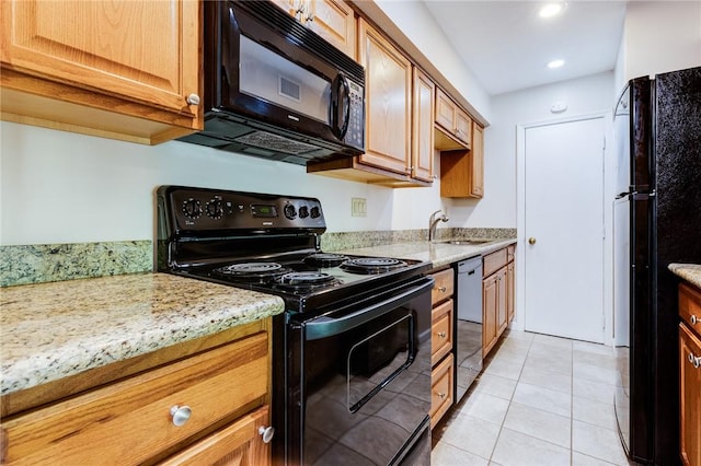 kitchen with black appliances, a sink, light tile patterned floors, light stone countertops, and recessed lighting