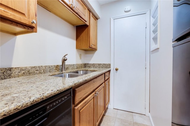 kitchen with a sink, black dishwasher, light stone countertops, fridge, and light tile patterned flooring