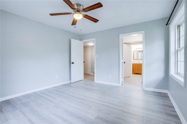 unfurnished bedroom featuring light wood-style flooring, baseboards, and ceiling fan