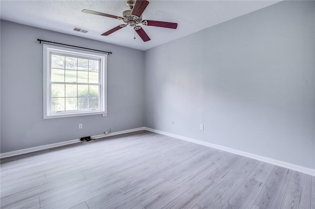 empty room with wood finished floors, baseboards, and ceiling fan