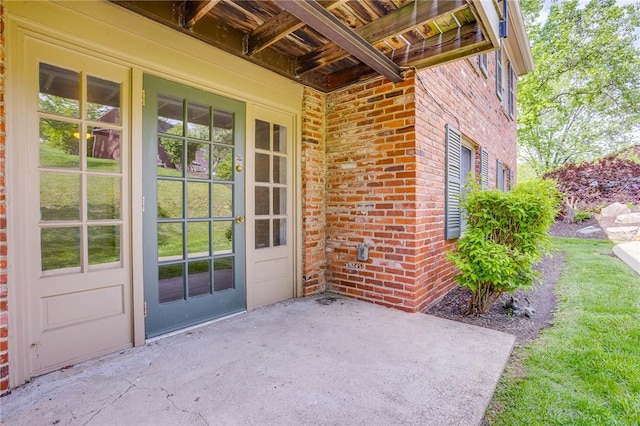property entrance featuring brick siding