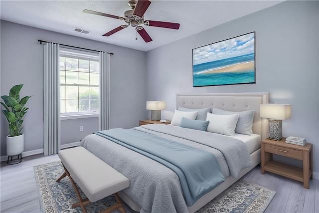 bedroom featuring light wood-style floors, baseboards, and a ceiling fan