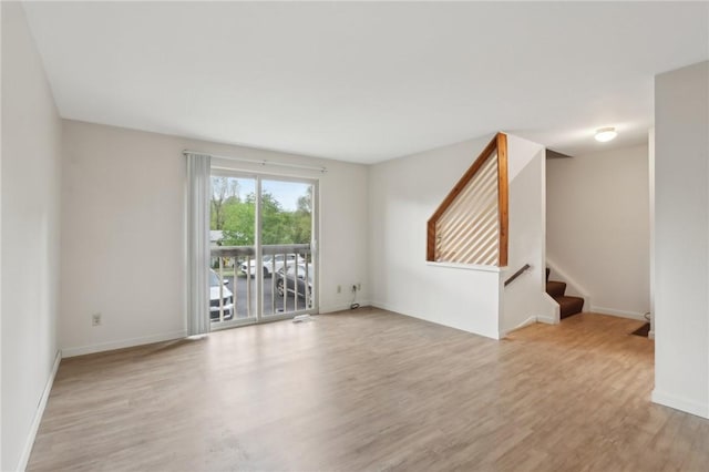 207 Parkwood Dr, Cranberry Twp, PA 16066 - unfurnished living room featuring wood finished floors, baseboards, and stairs