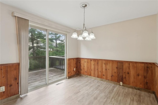 207 Parkwood Dr, Cranberry Twp, PA 16066 - unfurnished dining area with wood finished floors, wainscoting, a chandelier, and wooden walls