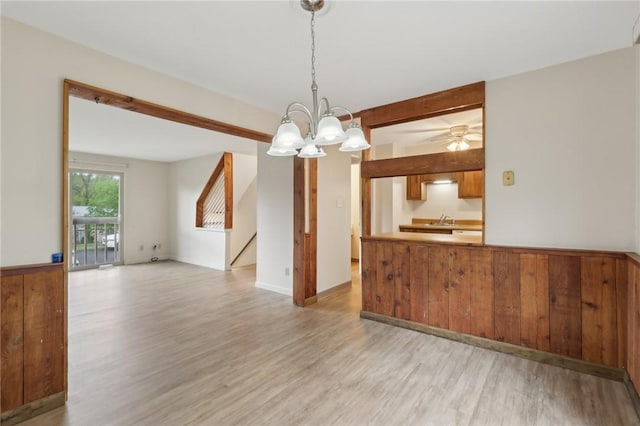 207 Parkwood Dr, Cranberry Twp, PA 16066 - kitchen featuring light wood finished floors, a sink, beamed ceiling, a chandelier, and a peninsula