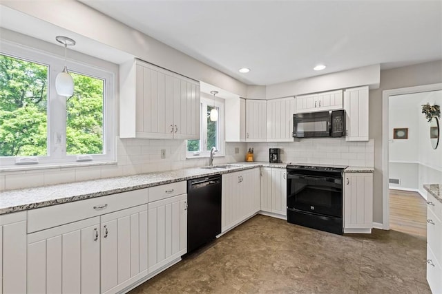kitchen with black appliances, a sink, plenty of natural light, decorative backsplash, and recessed lighting