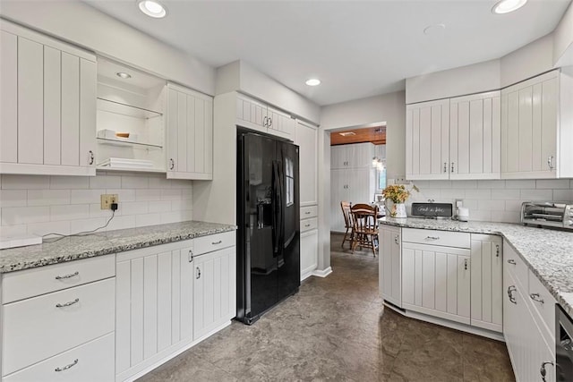 kitchen with black fridge with ice dispenser, tasteful backsplash, white cabinets, open shelves, and recessed lighting