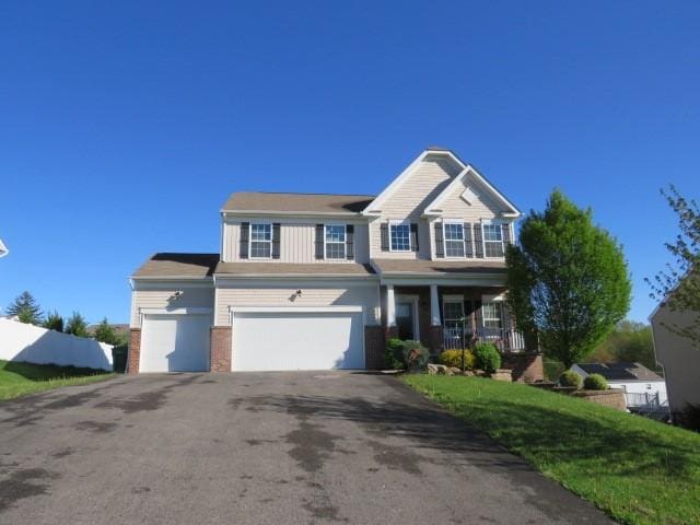 view of front of home with driveway, covered porch, an attached garage, and brick siding