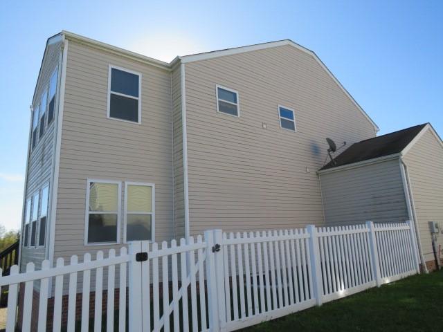 view of side of home with fence