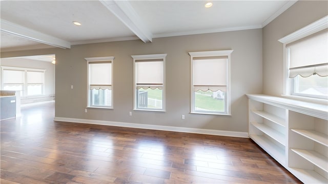 unfurnished room with beamed ceiling, plenty of natural light, dark wood-style flooring, baseboards, and crown molding