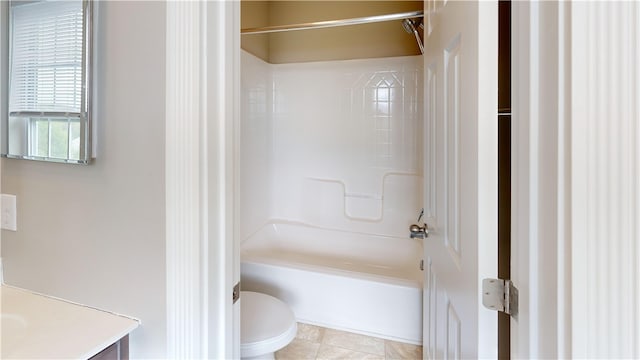 bathroom with toilet, vanity, bathing tub / shower combination, and tile patterned flooring
