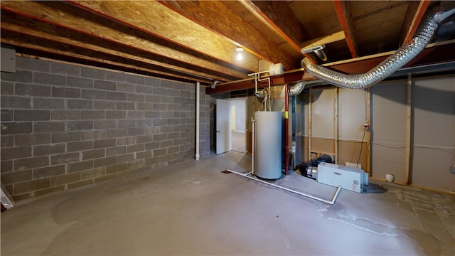 unfinished below grade area with gas water heater and concrete block wall