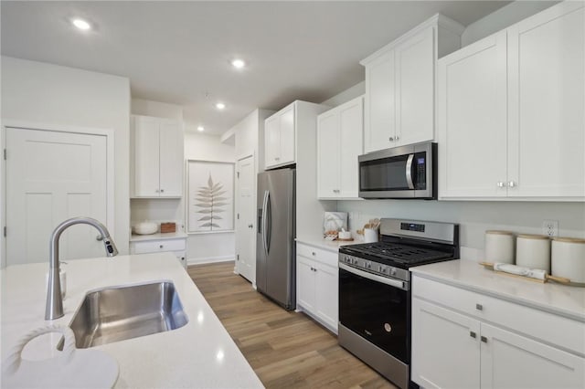 122 River Ridge Drive, Moon/Crescent Twp, PA 15108 - kitchen with appliances with stainless steel finishes, a sink, light wood finished floors, light countertops, and recessed lighting