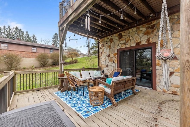 deck with an outdoor living space and a yard